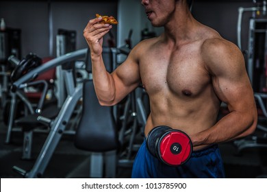 Strong Muscular Athlete Men With Pizza Fast Food. Unhealthy Eating Diet Concept.