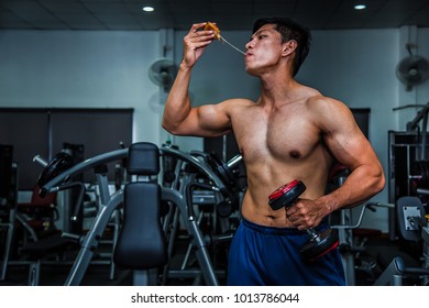 Strong Muscular Athlete Men With Pizza Fast Food. Unhealthy Eating Diet Concept.