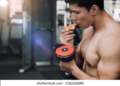 Strong Muscular Athlete Men With Pizza Fast Food. Unhealthy Eating Diet Concept.