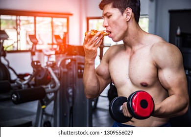 Strong Muscular Athlete Men With Pizza Fast Food. Unhealthy Eating Diet Concept.