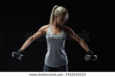 Similar – Rear view portrait of one young middle age athletic woman at crossfit training, exercising with trx suspension fitness straps over dark background