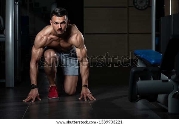 Strong Muscular Men Kneeling On Floor Stock Photo 1389903221 | Shutterstock