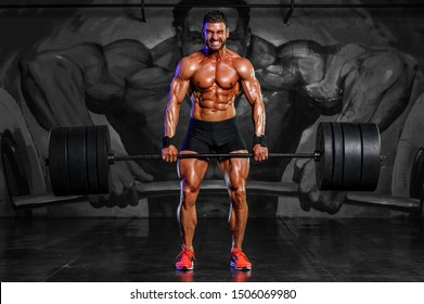 Strong Muscular Men Performing Heavy Deadlift Exercise With Barbells