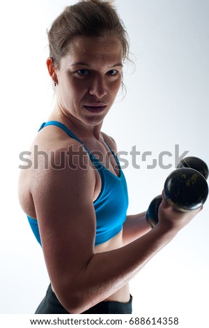 Similar – Close up front portrait of one young athletic woman in sportswear in gym over dark background, standing in boxing stance with hands and fists, looking at camera