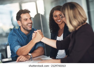 Strong Partners Make A Strong Business Relationship. Shot Of A Businesswoman And Businessman Shaking Hands During A Meeting In A Modern Office.