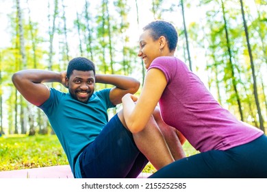 Strong And Powerful Afro American Couple In Love Are Working Out Abs Exercises Outside In Park Or Forest