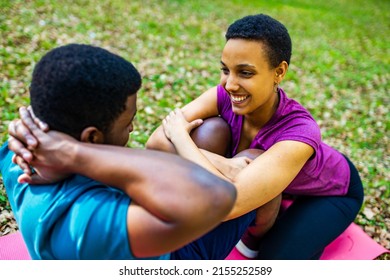 Strong And Powerful Afro American Couple In Love Are Working Out Abs Exercises Outside In Park Or Forest