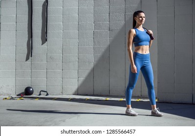 Strong powerful confident stance portrait by beautiful athletic model trainer in sportswear - Powered by Shutterstock