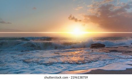 Strong sea waves crushing on rocky coast on stormy weather with cloudy dramatic sunset sky over the sea - Powered by Shutterstock