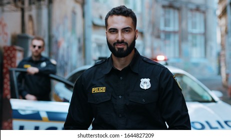 Strong Smiling Young Man Cops Stand Near Patrol Car Look At Camera Enforcement Officer Police Uniform Auto Safety Security Communication Control Policeman Close Up Slow Motion