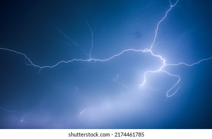 A Strong Storm With Bright Lightning Illuminating Ominous Clouds. Exotic Image Of Cloud Texture. Adverse Weather Conditions. Photo Wallpaper. Climate Change. Force Of Nature. Beauty Of Earth.