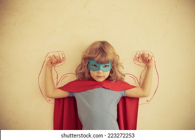 Strong superhero child. kid with drawn muscles. Girl power and feminism concept