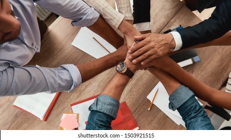 Strong Team. Top View Of Business People Holding Hands Together While Sitting In The Office