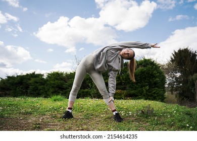 Strong Teen Girl Standing And Stretching Herself At The Park At Open Air