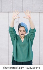 Strong Teen Young Woman Fighting For Gender Equality With The Feminist Symbol On Both Hands Isolated On The Street