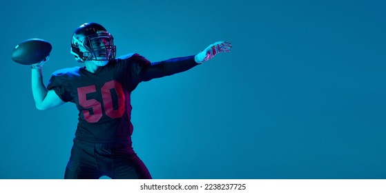 Strong throw. Professional american football player in sports team uniform and protective helmet isolated over blue background in neon light. Power, energy, achievements, skills. Flyer for ad - Powered by Shutterstock