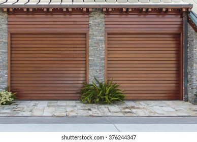 Strong Vertical Lines With Landscape Two Single Car Garage Doors