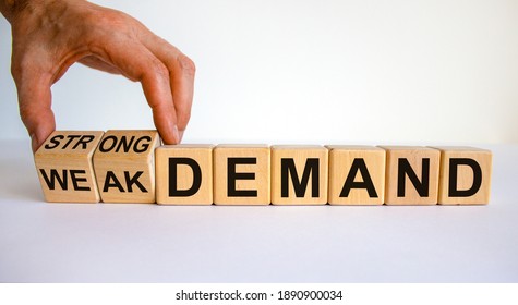Strong or weak demand symbol. Businessman hand turns cubes and changes words 'weak demand' to 'strong demand'. Beautiful white background. Business and strong demand concept. Copy space.