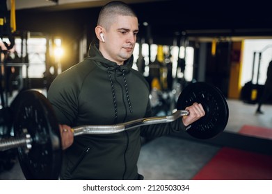 Strong And Well Built Bodybuilder Lifting Dumbbell Weights While Training In The Gym. Fitness Exercise. Weight Training Concept.