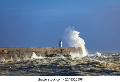 Strong winds and crashing waves at Newhaven lighthouse on the east Sussex coast south east England - Shutterstock ID 2248510399