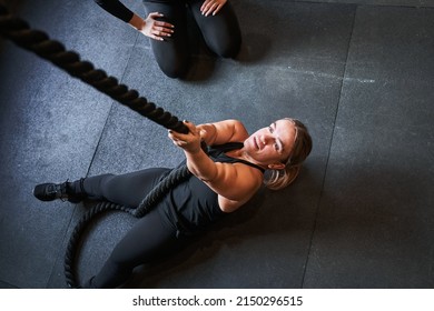 Strong Woman With Achondroplasia Disorder Pulling Rope At The Gym