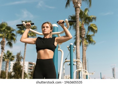 Strong woman athlete during her workout in outdoor gym - Powered by Shutterstock