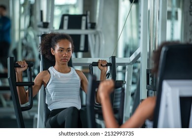 Strong Woman Athletic Workout Exercise Pulling Weight Lifting Machine At Fitness Club. Healthy Female Bodybuilder Do Body Building Muscle Weight Training At Sport Gym. Health Care Motivation Concept