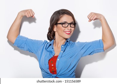 Strong woman. Beautiful young woman showing her muscularity and looking at camera while isolated on white