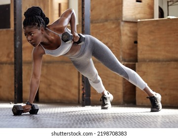 Strong woman doing fitness training for exercise at gym, weights for cardio workout and motivation for lifestyle and healthy body. African athlete doing sports on floor with equipment for wellness - Powered by Shutterstock