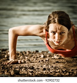 Strong Woman Doing Push Up At The Beach