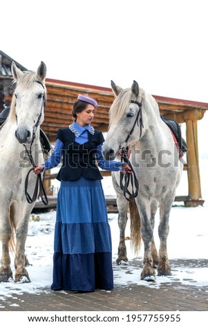 a strong woman drives with two horses