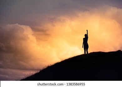 Strong Woman With Fist In The Air Standing On Top A Mountain. Triumph, Victory And Feeling Determined.  