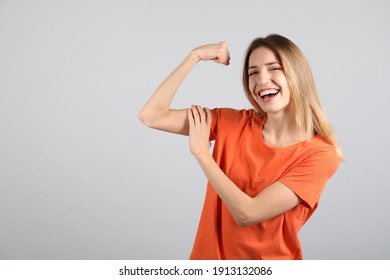 Strong Woman As Symbol Of Girl Power On Light Grey Background, Space For Text. 8 March Concept