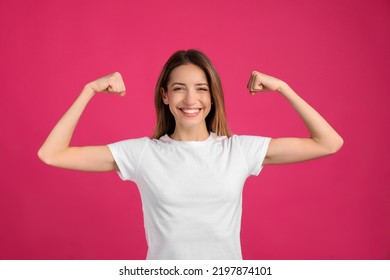 Strong woman as symbol of girl power on pink background. 8 March concept - Powered by Shutterstock