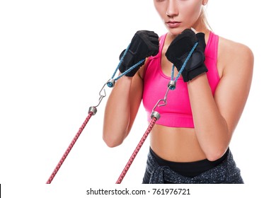 Strong Woman Using A Resistance Band In Her Exercise Routine. Young Woman Performs Fitness Exercises On White Background. Close Up