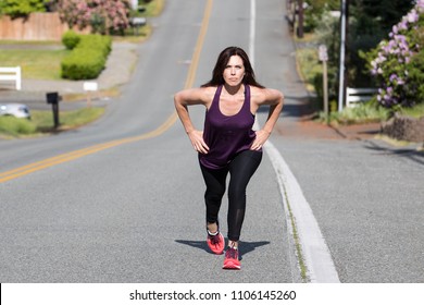 Strong woman walking uphill - Powered by Shutterstock