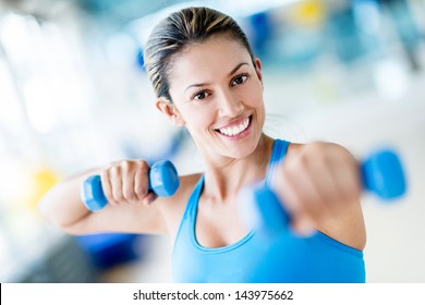 Strong Woman Weightlifting At The Gym Looking Happy