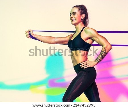 Similar – Image, Stock Photo One young athletic woman at crossfit training, exercising with trx suspension fitness straps over dark background, front view, looking at camera