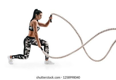 Strong Woman Workout With Battle Ropes. Photo Of Latin Woman In Military Sportswear Isolated On White Background. Strength And Motivation. Side View.