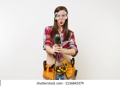 Strong Young Energy Handyman Woman In Plaid Top Shirt Denim Shorts Kit Tools Belt Full Of Instruments In Protective Goggles Hold Power Electric Drill Isolated On White Background. Female In Male Work