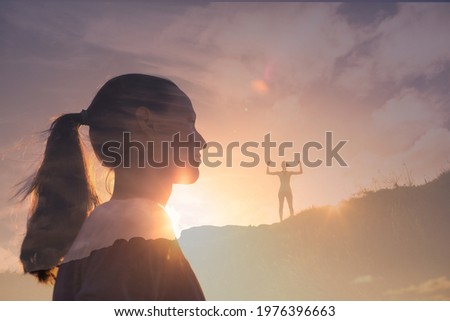 Strong young girl woman facing the sunset on top a mountain. 