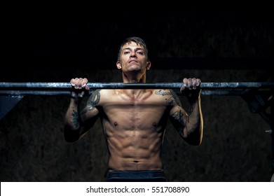 Strong Young Man Doing Pull Up Exercise On Horizontal Bar In Gym. Sports, Fitness, Gymnastics Workout.