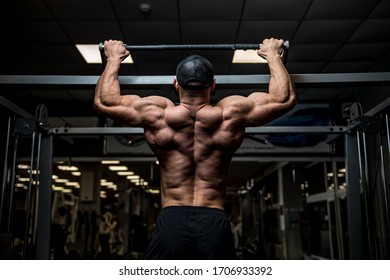 Strong Young Man Lifting His Heavy Weight Body During Chin Ups On Horizontal Bar In Sport Gym