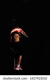 Strong Young Woman Doing Pull-ups Exercise Using Gymnastic Rings At Gym, Shot From Below, Low Angle, High Contrast