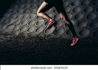 Strong Young Woman Running, Sprinting At Night In Urban Scene