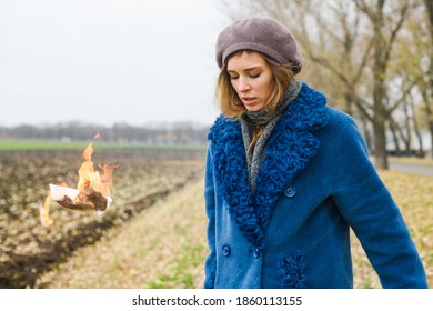 Strong Young Woman Throw Burning Paper Outdoors