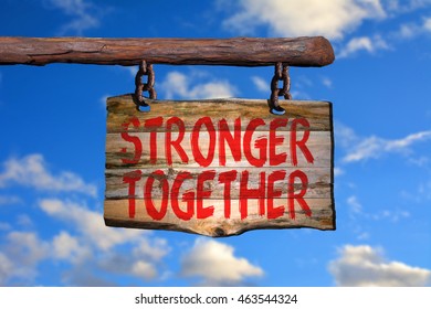 Stronger Together Motivational Phrase Sign On Old Wood With Blurred Background