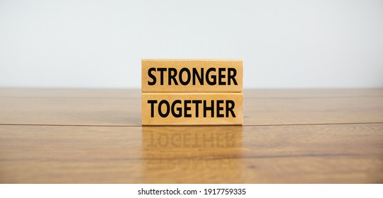 Stronger Together Symbol. Concept Words 'stronger Together' On Wooden Blocks On A Beautiful Wooden Table, White Background. Business, Motivational And Stronger Together Concept.