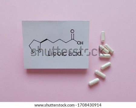 Structural chemical formula of alfa lipoic acid molecule with pills. Lipoic acid (ALA, Thioctic acid) is an organosulfur compound, antioxidant, enzyme cofactor; used as a dietary supplement.