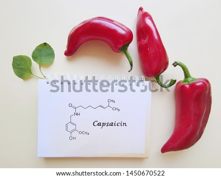 Structural chemical formula of capsaicin molecule with red chili peppers. Capsaicin is a chili pepper extract with analgesic properties, and an active component of chili peppers.